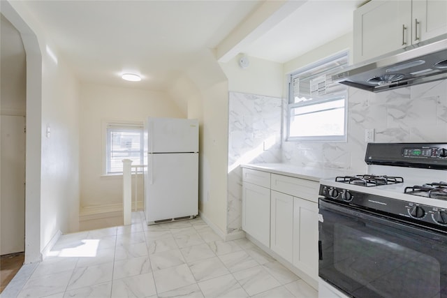 32-12 208th St, Bayside, NY 11361 - kitchen with freestanding refrigerator, a healthy amount of sunlight, gas range, and under cabinet range hood