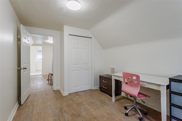 32-12 208th St, Bayside, NY 11361 - home office featuring light wood-style flooring, lofted ceiling, and baseboards