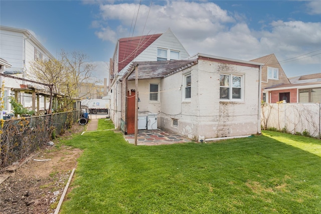 32-12 208th St, Bayside, NY 11361 - rear view of house with brick siding, a yard, a patio area, and a fenced backyard