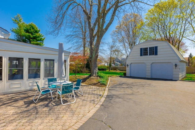 exterior space with a detached garage and an outdoor structure