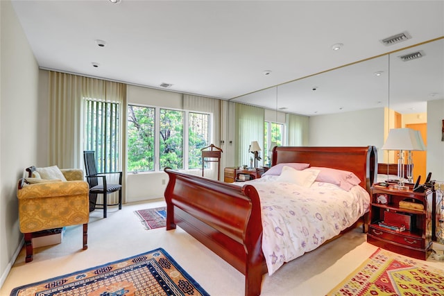 carpeted bedroom with recessed lighting and visible vents