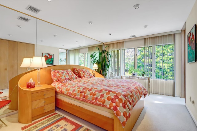 bedroom with visible vents and multiple windows