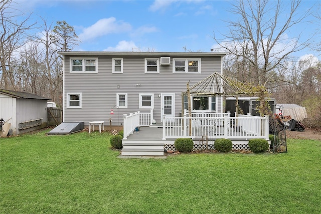 back of property with a wooden deck and a yard
