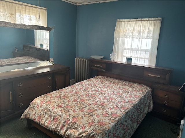 carpeted bedroom featuring radiator
