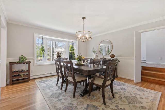 dining space with light wood-type flooring, an inviting chandelier, a baseboard radiator, and crown molding