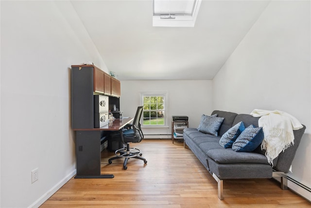 home office with light wood-style floors, lofted ceiling, and baseboard heating