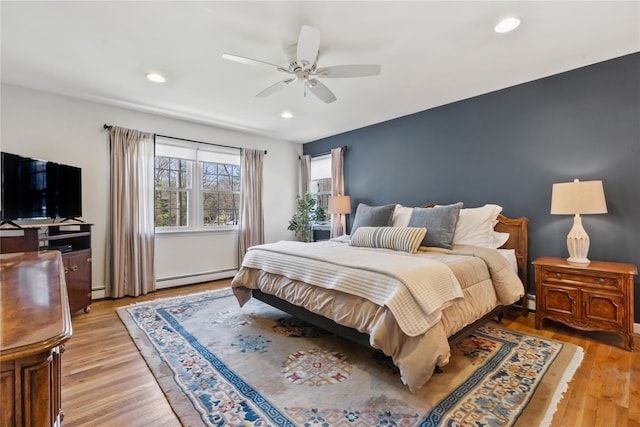 bedroom with a baseboard heating unit, light wood-type flooring, recessed lighting, a ceiling fan, and a baseboard radiator