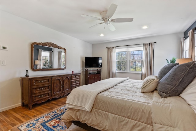 bedroom with wood finished floors, recessed lighting, ceiling fan, and multiple windows