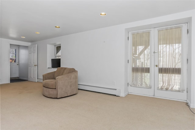 sitting room featuring a baseboard radiator, recessed lighting, french doors, and carpet