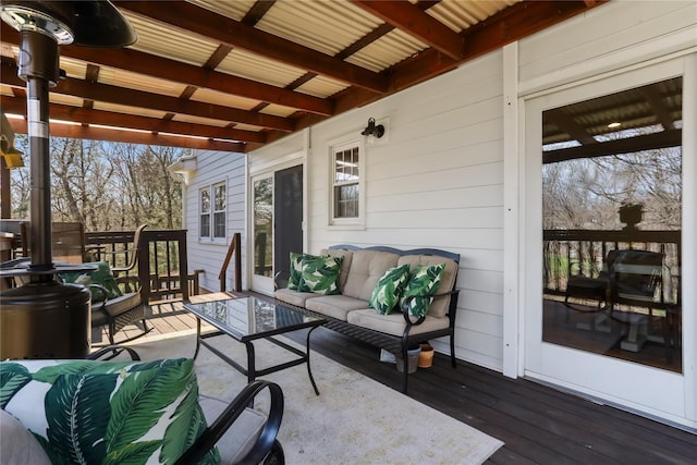 wooden terrace with an outdoor hangout area