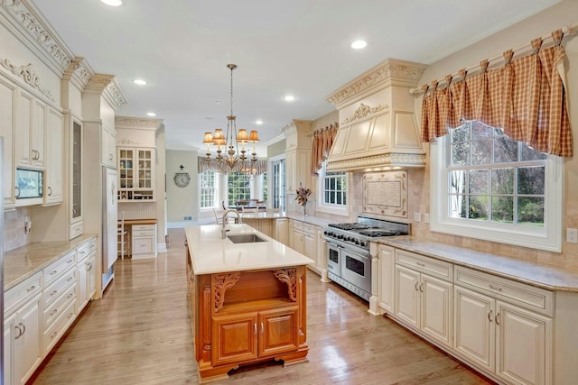 85 Woodlands Rd, Harrison, NY 10528 - kitchen featuring double oven range, a chandelier, a sink, decorative backsplash, and light wood-style floors