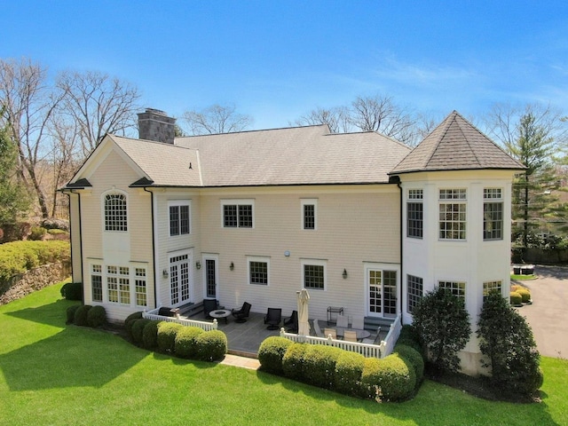 85 Woodlands Rd, Harrison, NY 10528 - back of house with a lawn, a patio, a chimney, and french doors