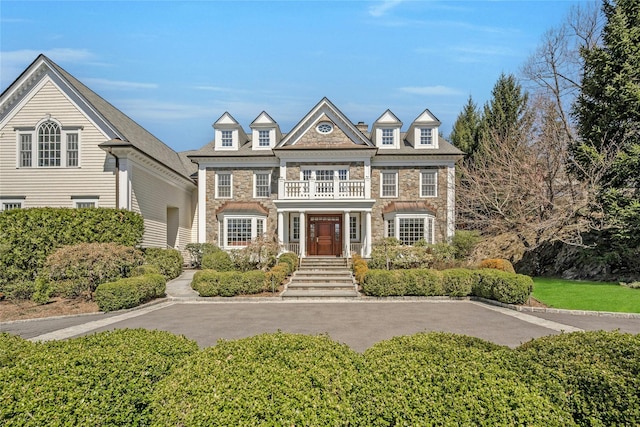 85 Woodlands Rd, Harrison, NY 10528 - view of front of house featuring stone siding and a balcony