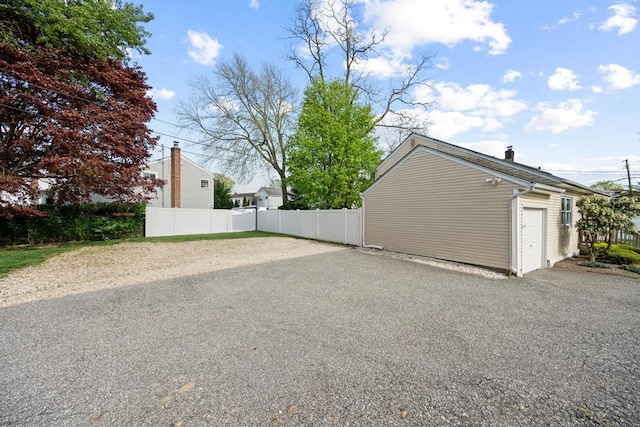 exterior space with fence and aphalt driveway