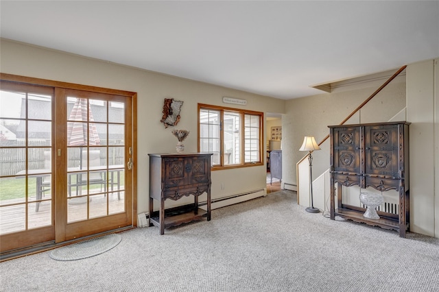 interior space with stairway, a baseboard radiator, and carpet flooring