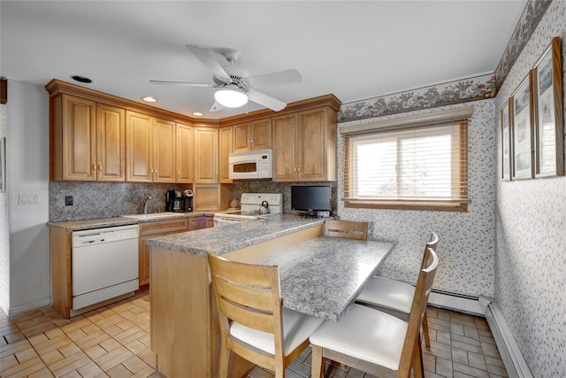 kitchen featuring a baseboard radiator, a peninsula, wallpapered walls, and white appliances