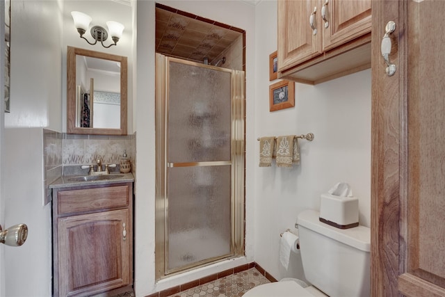 full bathroom featuring tile patterned floors, toilet, vanity, tasteful backsplash, and a stall shower
