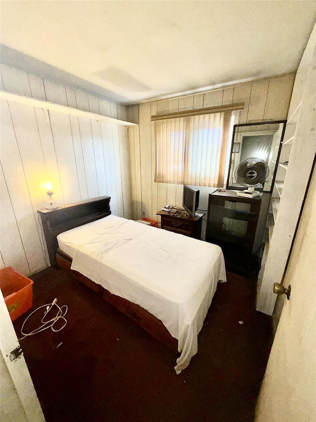 bedroom with wooden walls