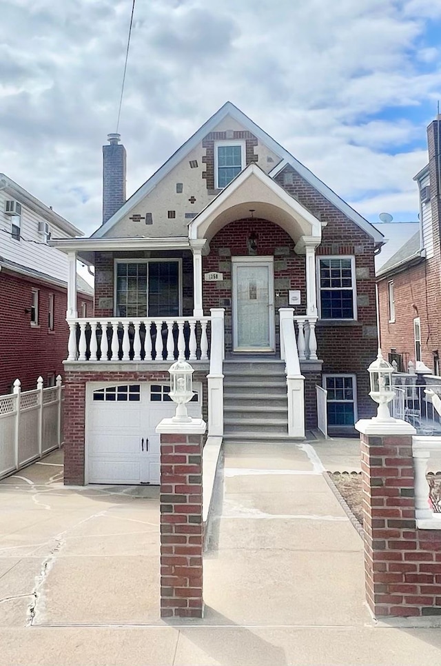 1258 Mace Ave, Bronx, NY 10469 - view of front facade with an attached garage, fence, brick siding, and concrete driveway