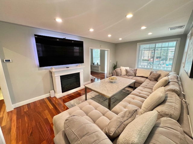 1258 Mace Ave, Bronx, NY 10469 - living room featuring wood finished floors, a glass covered fireplace, baseboards, visible vents, and recessed lighting