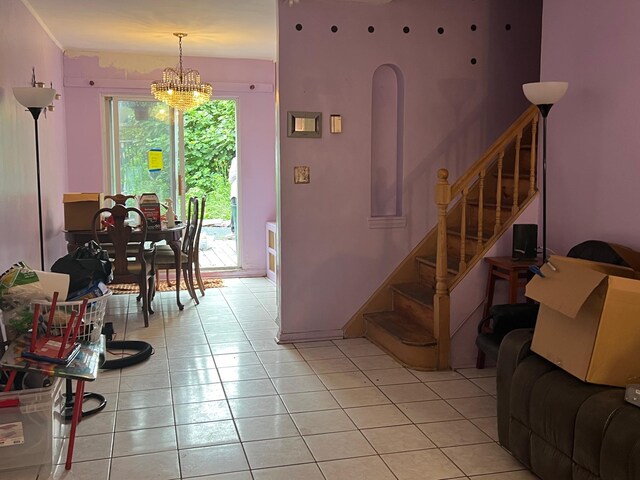 47-65 196th St, Flushing, NY 11358 - living room with stairway, a chandelier, and light tile patterned flooring