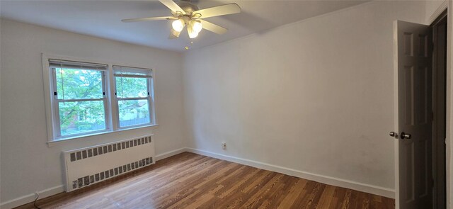47-65 196th St, Flushing, NY 11358 - unfurnished room featuring radiator heating unit, wood finished floors, and ceiling fan