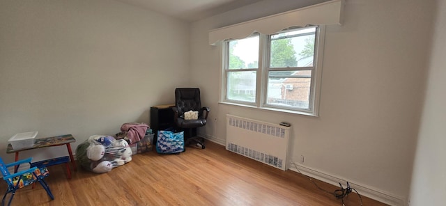 47-65 196th St, Flushing, NY 11358 - spare room featuring radiator heating unit and wood finished floors