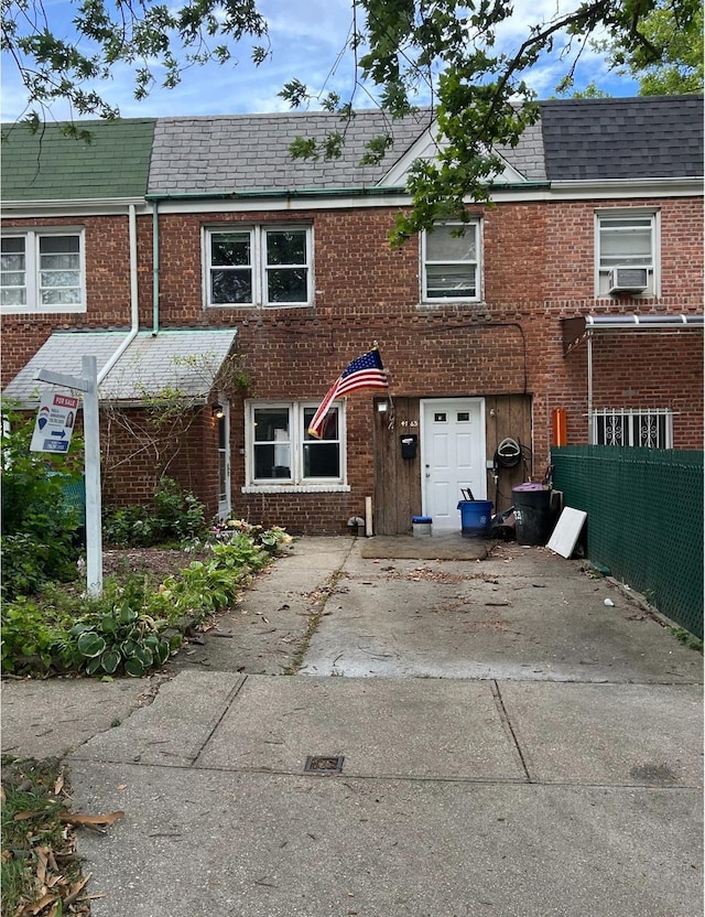 47-65 196th St, Flushing, NY 11358 - townhome / multi-family property with brick siding, mansard roof, and cooling unit