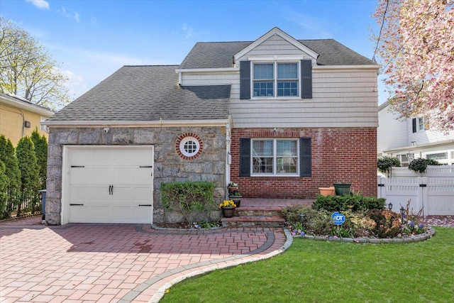 80 Park Ave, New Hyde Park, NY 11040 - view of front facade with fence, an attached garage, a shingled roof, a front yard, and decorative driveway