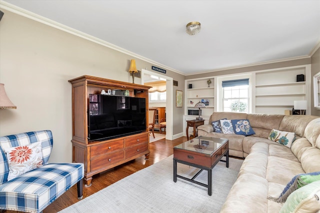 80 Park Ave, New Hyde Park, NY 11040 - living area featuring built in shelves, a healthy amount of sunlight, wood finished floors, and crown molding