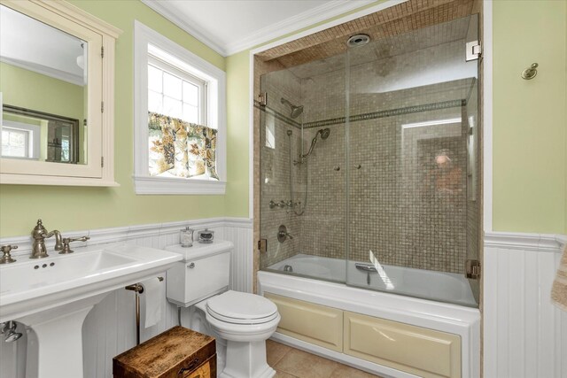 80 Park Ave, New Hyde Park, NY 11040 - bathroom featuring toilet, ornamental molding, a wainscoted wall, and combined bath / shower with glass door