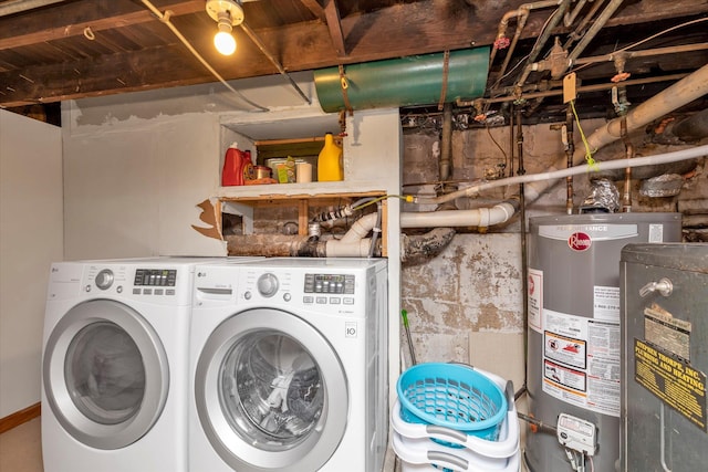 clothes washing area with gas water heater and washer and clothes dryer