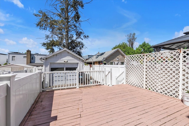 wooden terrace featuring a residential view, fence, and an outbuilding