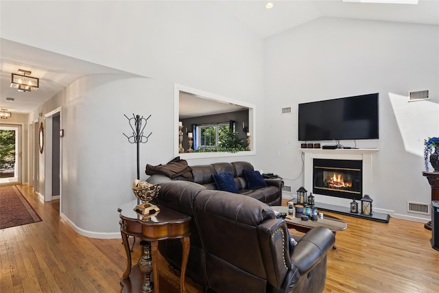 living room with visible vents, plenty of natural light, and light wood-type flooring