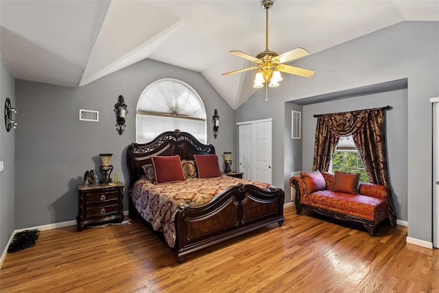 bedroom featuring a ceiling fan, vaulted ceiling, light wood-style flooring, and visible vents