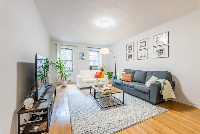 living area with baseboards and hardwood / wood-style floors