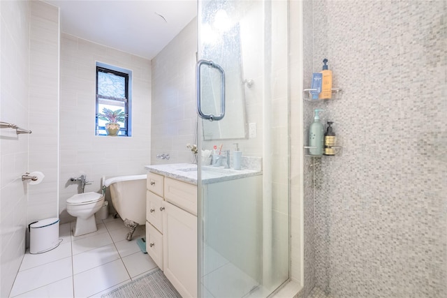 bathroom with a stall shower, tile patterned floors, tile walls, and vanity