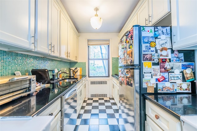 kitchen featuring a sink, tile patterned floors, radiator heating unit, stainless steel appliances, and tasteful backsplash