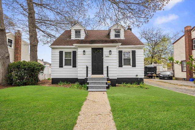 22 Wagner Ave, Roosevelt, NY 11575 - cape cod home with roof with shingles and a front yard