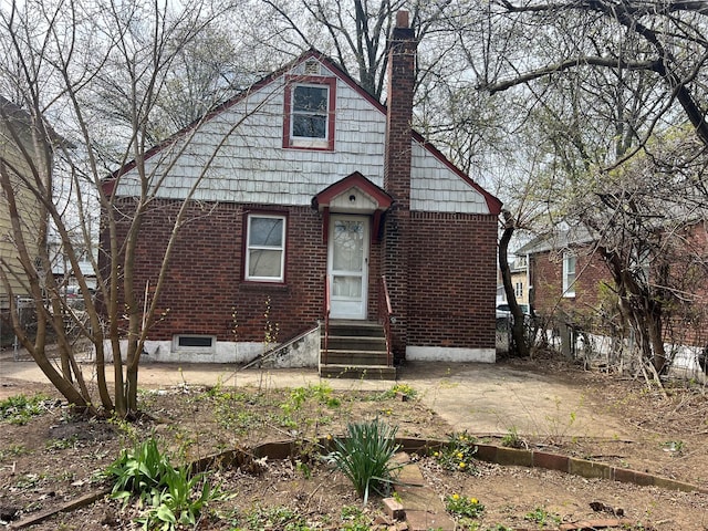 bungalow-style home with entry steps and a chimney