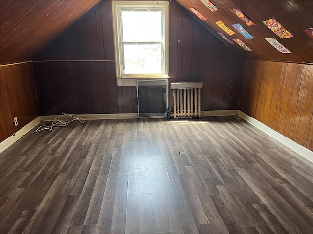 bonus room featuring radiator, hardwood / wood-style floors, wooden walls, vaulted ceiling, and wood ceiling