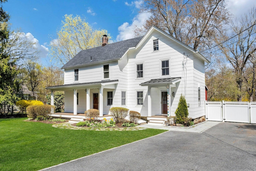 48 Granite Springs Rd, Granite Springs, NY 10527 - view of front of home with a front lawn, fence, covered porch, a chimney, and a gate