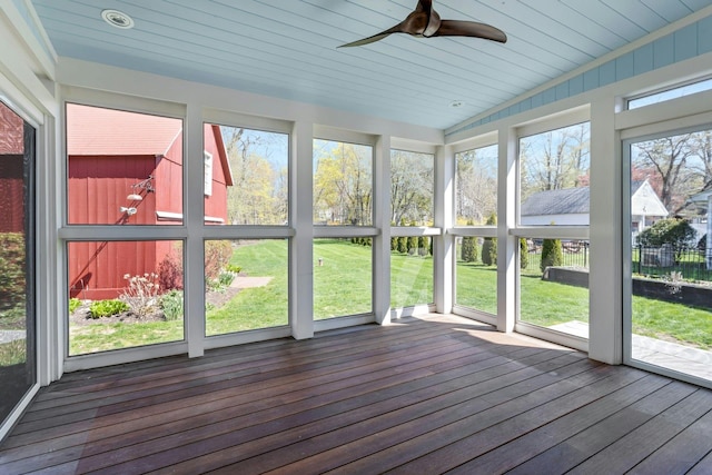 unfurnished sunroom with a ceiling fan