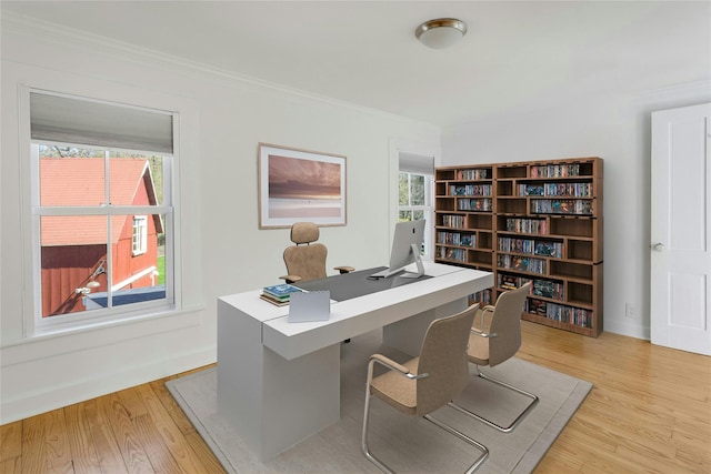 home office featuring light wood-type flooring and ornamental molding