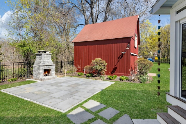 exterior space featuring fence, an outdoor structure, entry steps, and an outdoor stone fireplace