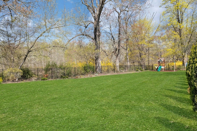 view of yard featuring a playground and fence