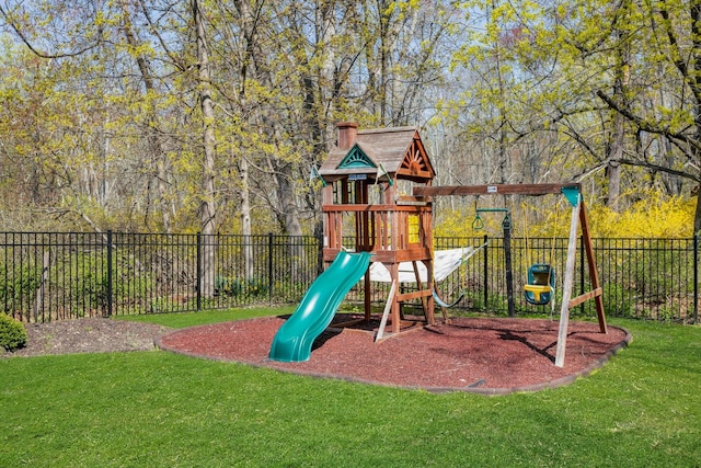 view of play area featuring fence and a lawn