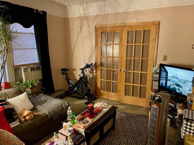 carpeted living room featuring baseboard heating and french doors
