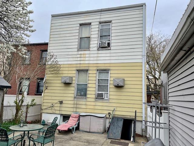 back of house with cooling unit, fence, and a patio