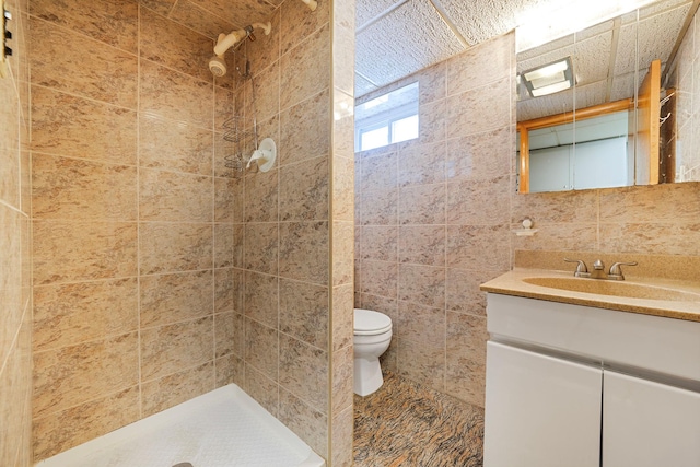 1041 N 6th St, New Hyde Park, NY 11040 - bathroom featuring toilet, tiled shower, vanity, and tile walls